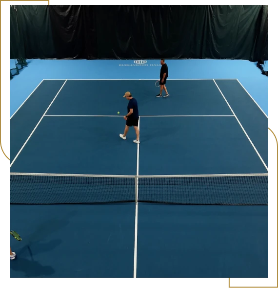 Members playing pickleball together on indoor courts at the club in Burlington.