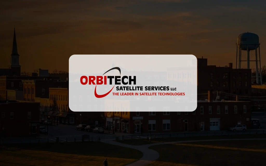 A technician installing communication equipment on a commercial building rooftop while setting up facility technology systems.