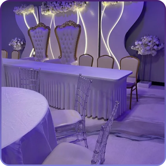A banquet hall in Aurora, CO set up for a formal reception with round tables and lighting.