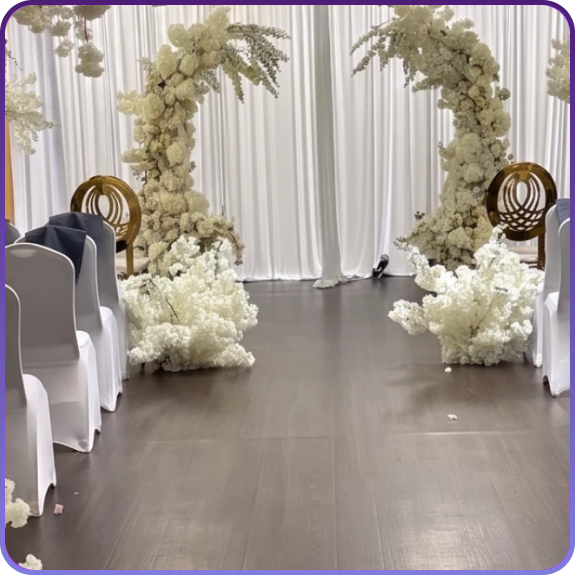 A banquet hall in Aurora, CO set up for a formal reception with round tables and lighting.
