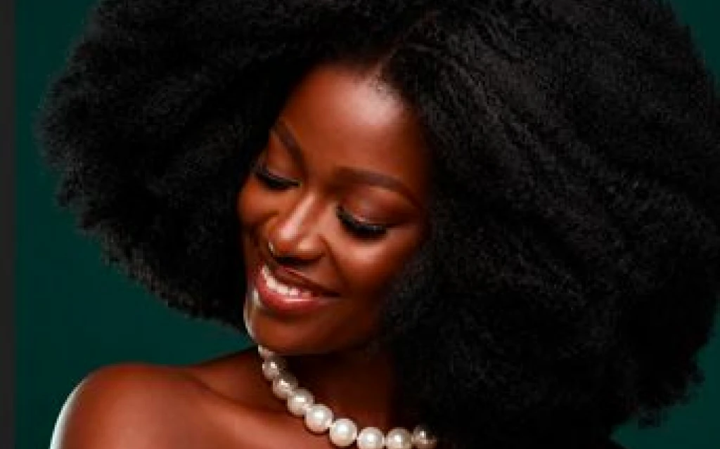 Scalp massage using hair growth oil solutions in a relaxing salon environment.