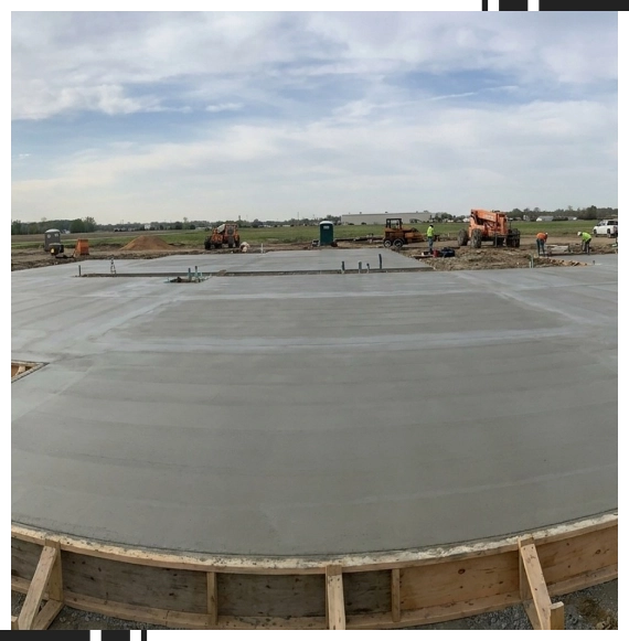 Workers setting concrete for foundation at a build in Ontario