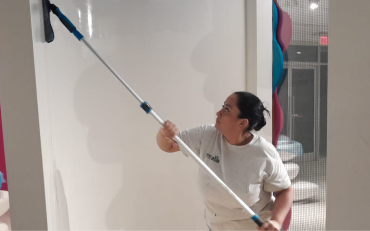Technician applying green cleaning methods on office floors in Atlanta
