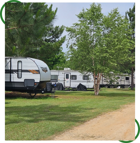 Fishing pond at an RV park with trees in Dothan, Alabama