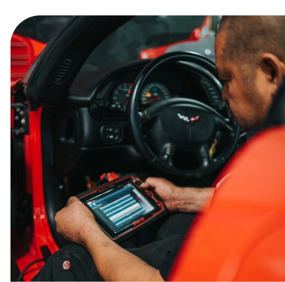 Mechanic recharging refrigerant during car AC repair in Los Angeles