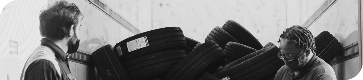 Mechanic performing mobile tire repair in Los Angeles at office lot