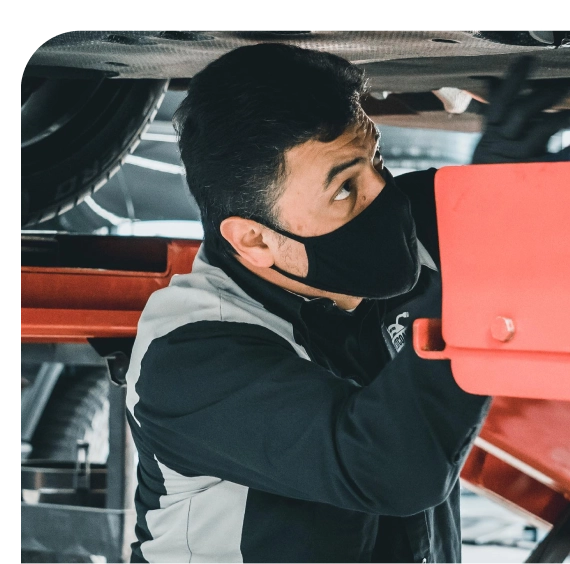 Mechanic inspecting joints during car suspension services in Los Angeles