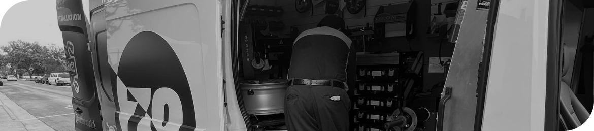 Mobile tire installation van servicing vehicle in Los Angeles parking lot