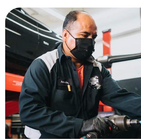 Technician performing Tesla service in Los Angeles on EV system