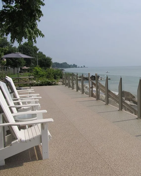 Safety railing installation with post caps, lighting, and finishing trim on a coastal vinyl deck