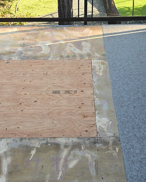 Vinyl deck installation in progress showing waterproof sheet placement and substructure preparation