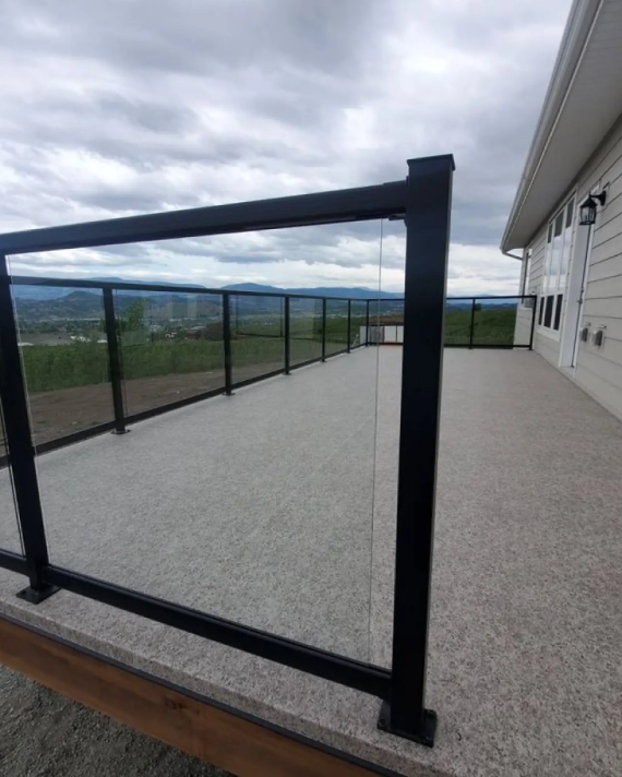 Safety railing installation with post caps, lighting, and finishing trim on a coastal vinyl deck
