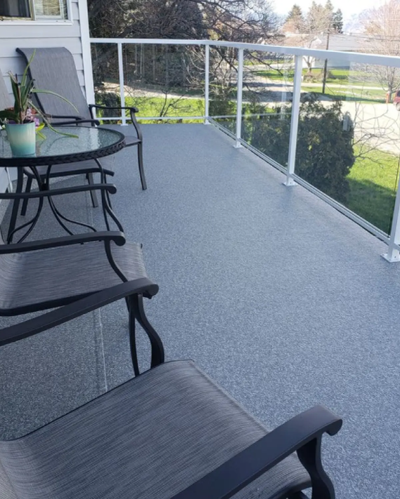 Waterproof vinyl deck with aluminum and glass railing on a coastal home