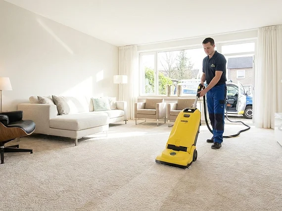 Carpet being steam cleaned in a living room — carpet cleaning services