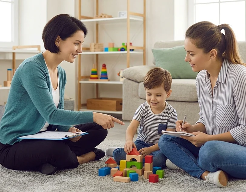 Caregivers receiving family ABA support during a coaching session