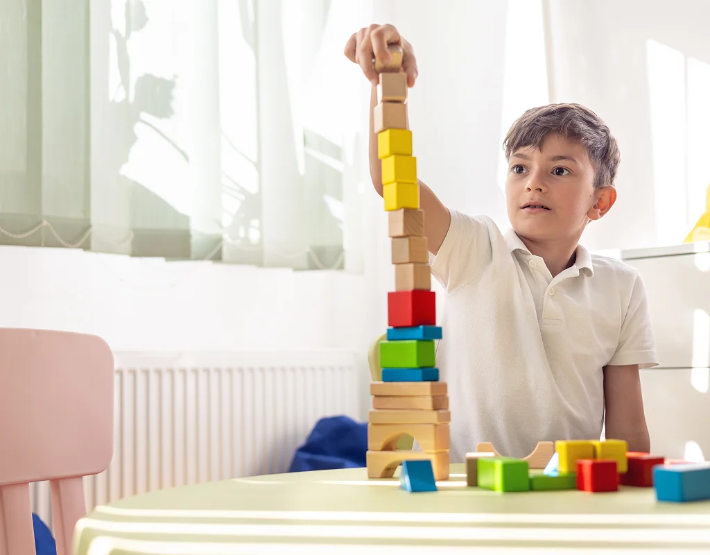 Child and caregiver celebrating milestones with therapist support in Sun City