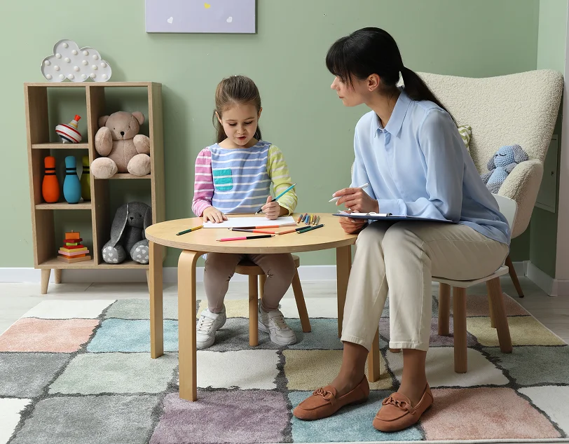 Therapist reviewing results from autism assessments with caregivers