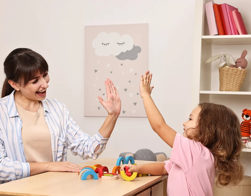Therapist guiding play-based early intervention ABA therapy sessions