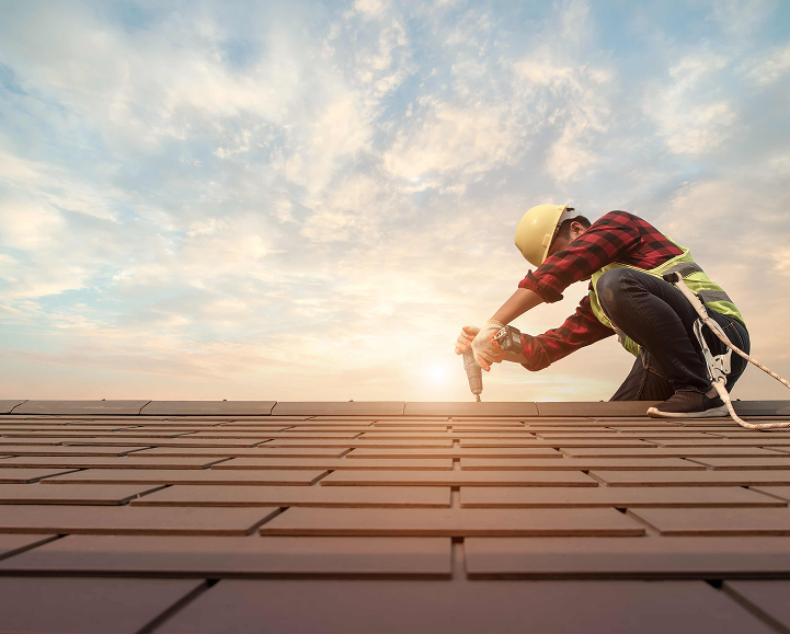 Contractors inspecting a roof before roofing installation in Los Angeles.