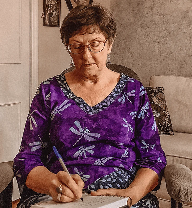 Pamela Van Nest, midlife life coach for women, writing in a notebook