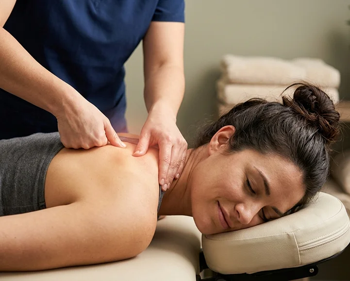 Therapist easing muscle tension during a relaxation massage at Parm's Wellness Spa