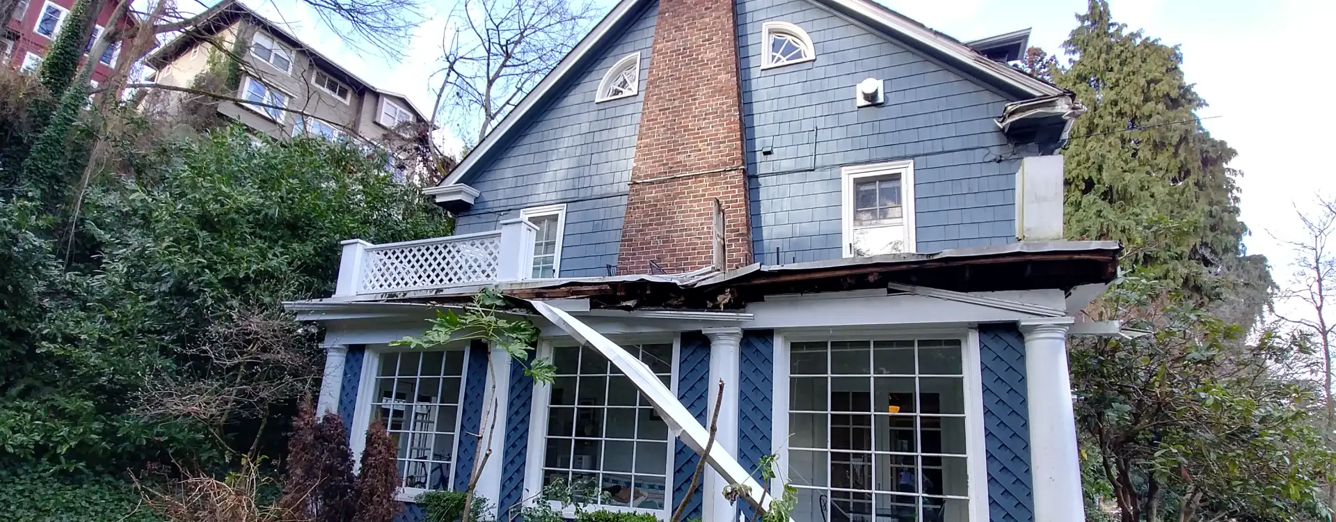 Tree damage repair in Seattle, WA, after a large tree struck a home.