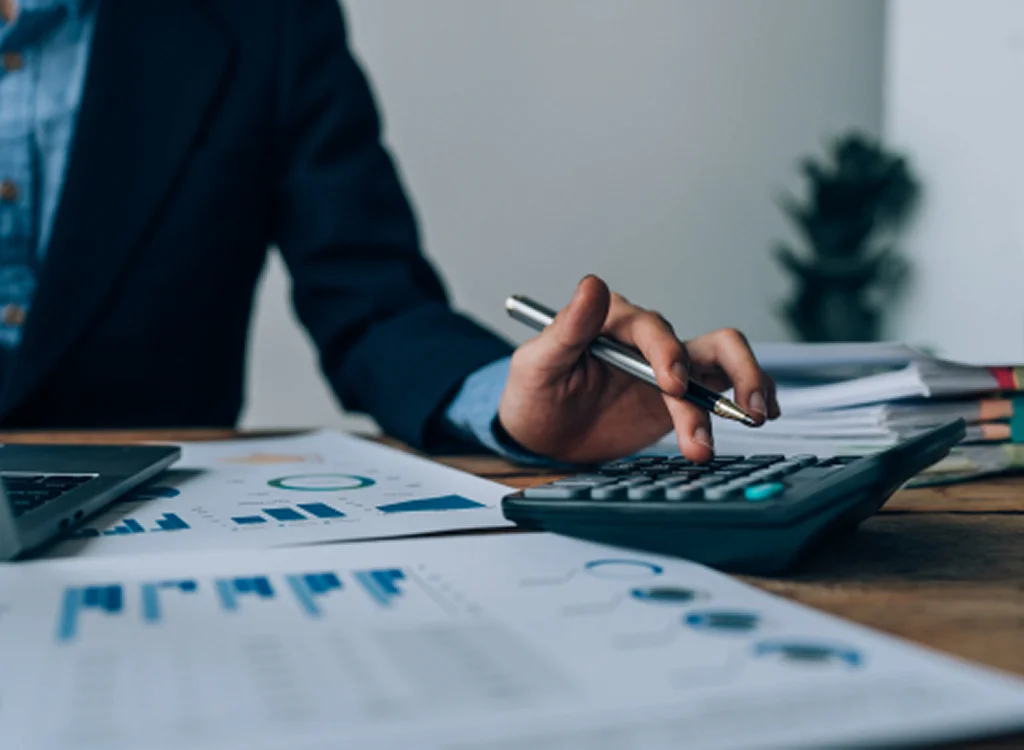 Bookkeeper reviewing reports for bookkeeping solutions for organization

