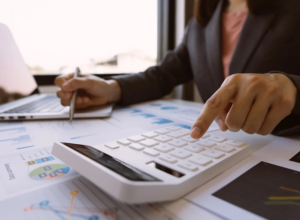 Bookkeeper reviewing disorganized records for bookkeeping cleanup services
