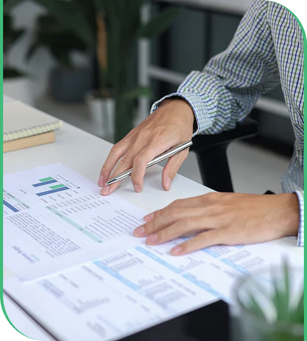 Licensed bookkeepers working with a business owner at a desk