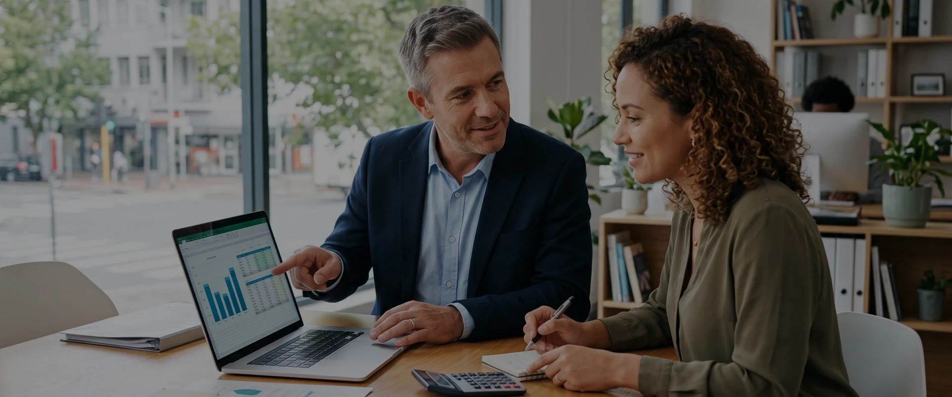 Bookkeeper reviewing financial reports for bookkeeping solutions