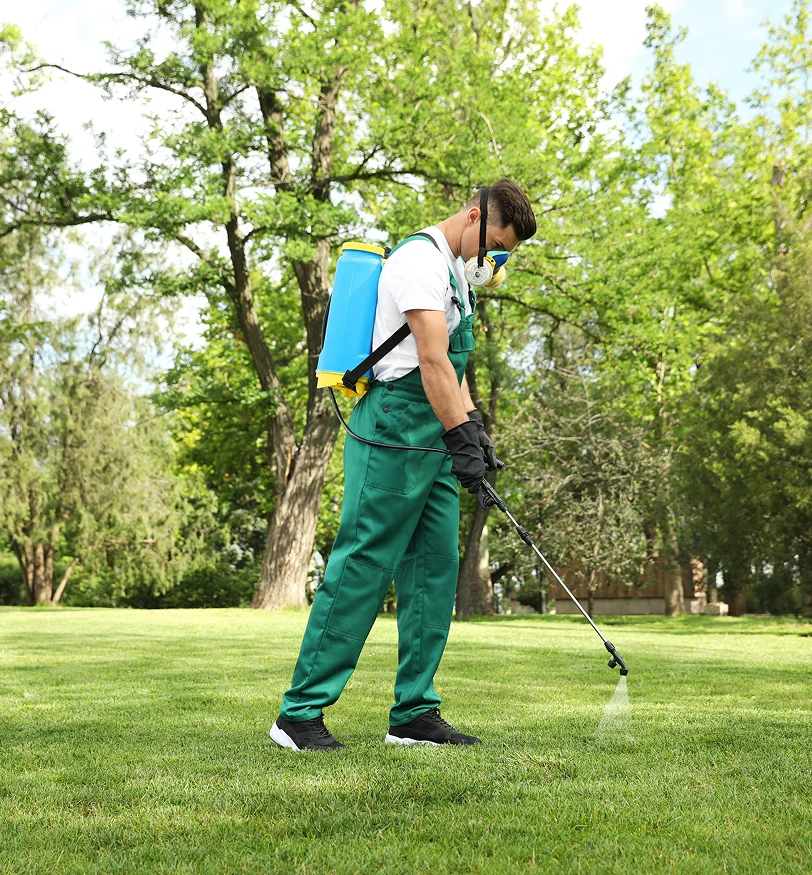 Technician providing pest control services in Euclid at a residential home.