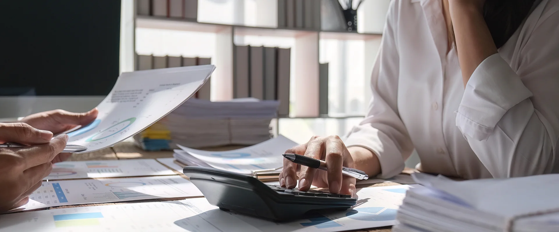 Bookkeeper providing bookkeeping services in Davis County at a desk