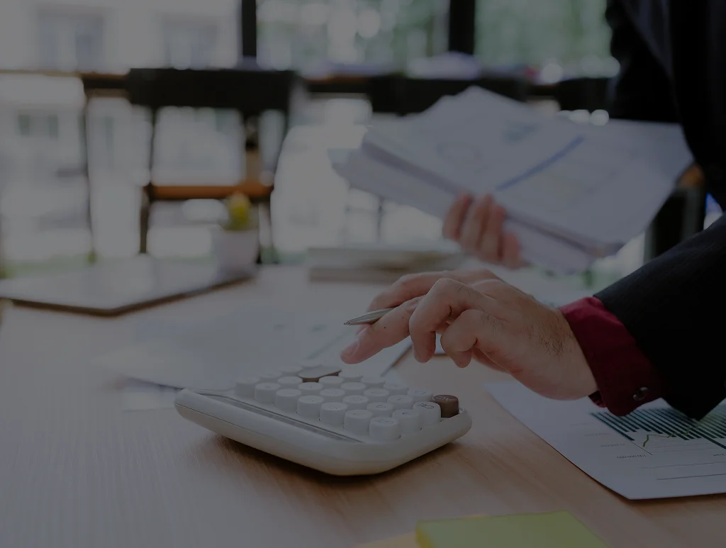 Bookkeeper reviewing invoices for accounts receivable services